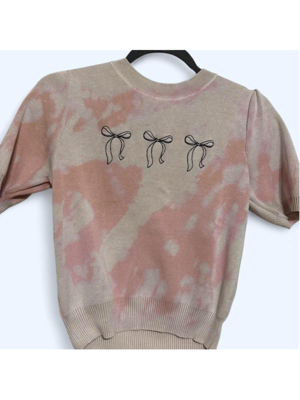 Doe brand pink and off-white bleach-dye sweater with three black bow graphics, s
